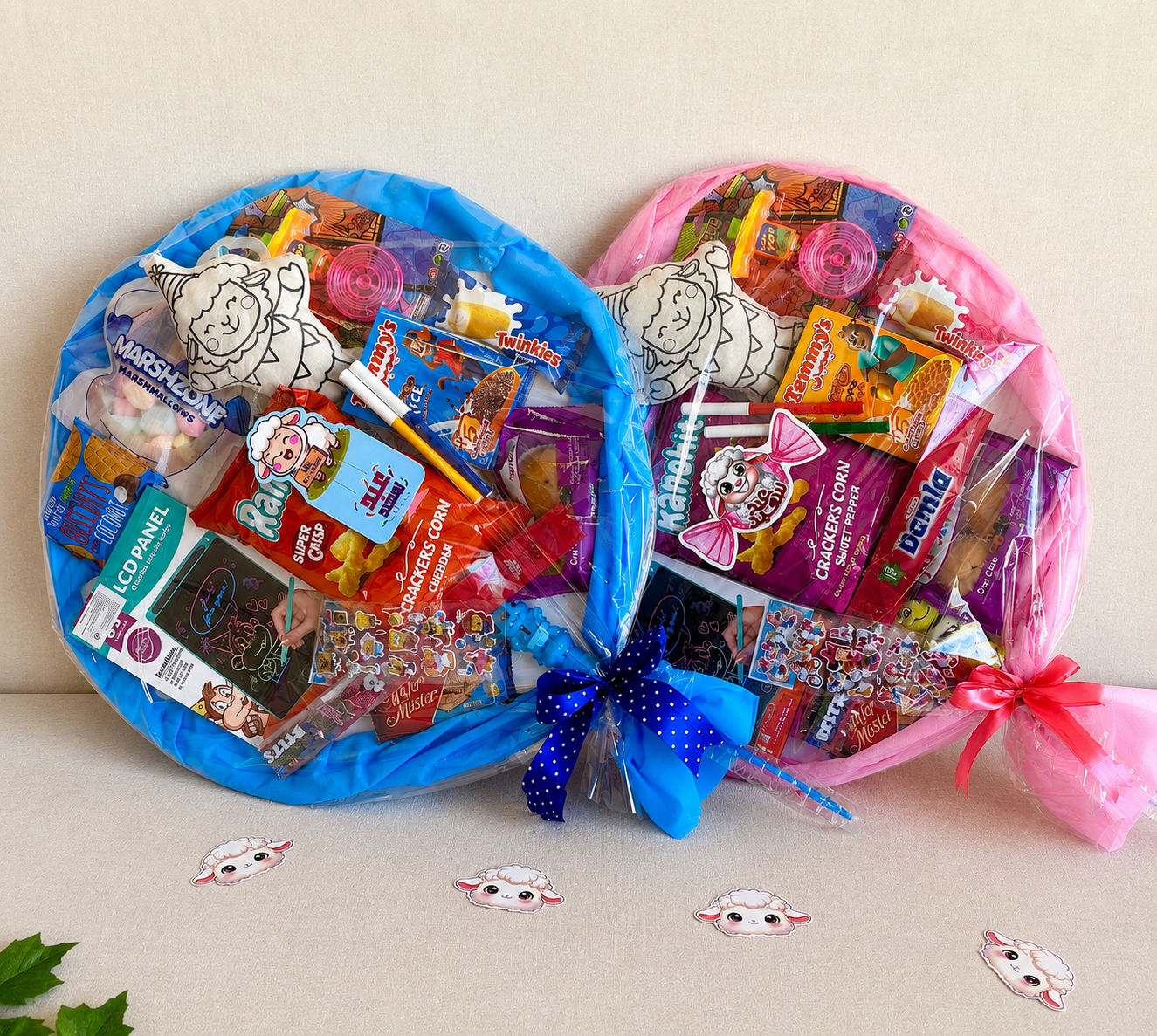 Two circular candy bouquets, one blue and one pink, filled with various candies on a beige background.